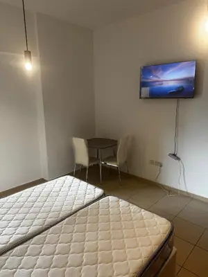 a room with two beds and a tv on the wall at TWIN BED-ROOM Sadaf Community near TRAM in Dubai