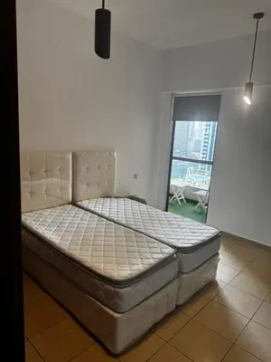 a large bed in a room with a window at TWIN BED-ROOM Sadaf Community near TRAM in Dubai