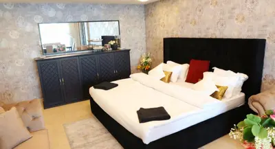 a bedroom with a large bed and a window at Luxury Apartment by oima leasing property in Dubai