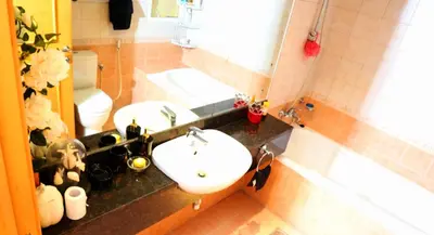 a bathroom with a sink and a toilet at Royal Classic by oima leasing property in Dubai