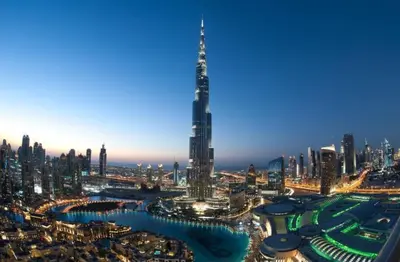 a view of a city with a tall skyscraper at Decent Room with Balcony Near Mall of the Emirates in Dubai