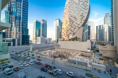 a city skyline with skyscrapers and cars in a city at Charm Studio Fully Furnished with Style in Dubai