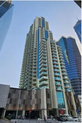 a large tall building in a city at Charm Studio Fully Furnished with Style in Dubai