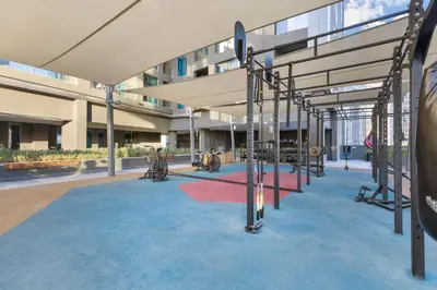 a building with a playground in front of a building at Waves - Spacious 2BR Apartment with Burj Views & Terrace in Dubai