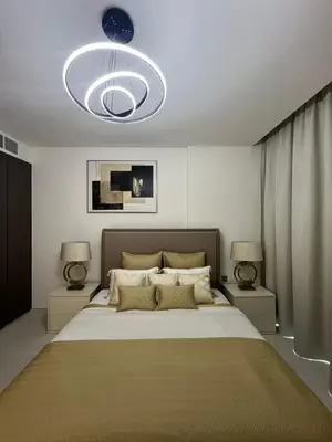 a bedroom with a large bed with two lamps at 2 Bedrooms - District One Residences 13 in Dubai
