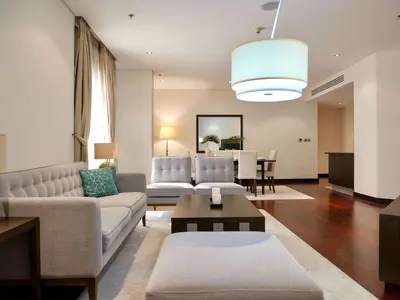 a living room with a couch and a table at Waterfront 2BR Apartment with Sea Views in Dubai
