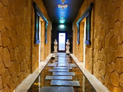 a long hallway with stone walls and a stone floor at Waterfront 2BR Apartment with Sea Views in Dubai