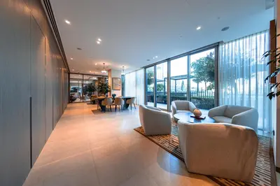 a lobby with chairs and a table and windows at Grande Signature Residence, Burj Khalifa and Fountain View in Dubai