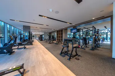 a gym with treadmills and ellipticals in a building at Grande Signature Residence, Burj Khalifa and Fountain View in Dubai