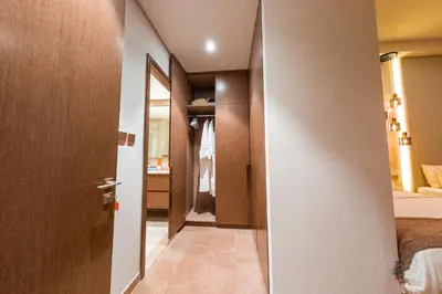 a hallway of a hotel room with a bedroom at Grande Signature Residence, Burj Khalifa and Fountain View in Dubai