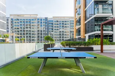 two ping pong tables on the roof of a building at Studio next Dubai Mall with pool in Dubai