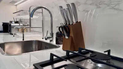 a kitchen with a stainless steel sink and a counter at Studio next Dubai Mall with pool in Dubai