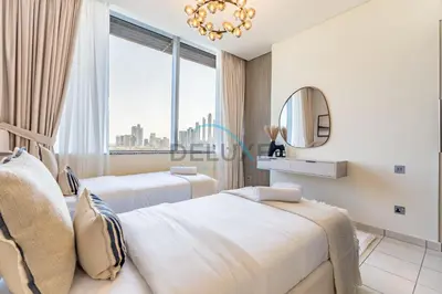a hotel room with two beds and a mirror at Elegant 2BR in Sky Gardens DIFC by Deluxe Holiday Homes in Dubai