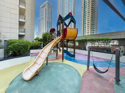 a playground with a slide in a park at Kensington Chic 1BR Fountain-view Flat Downtown Burj Khalifa in Dubai