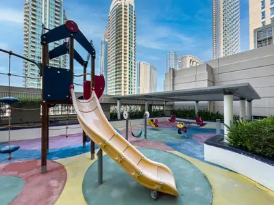 a playground with a slide in a city at Kensington Chic 1BR Fountain-view Flat Downtown Burj Khalifa in Dubai