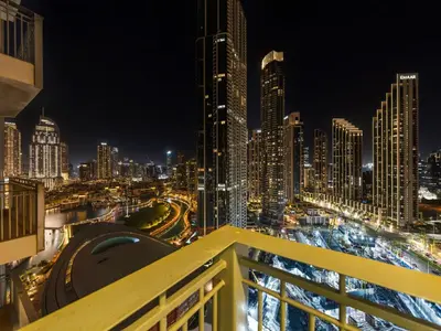 a view of a city skyline at night at Kensington Chic 1BR Fountain-view Flat Downtown Burj Khalifa in Dubai