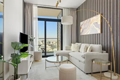 a living room with a couch and a table at Modern and High Floor 1BR at Binghatti Emerald in Dubai