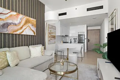a living room with a couch and a table at Modern and High Floor 1BR at Binghatti Emerald in Dubai