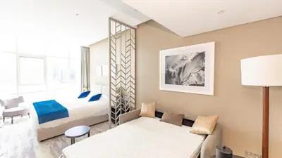 a hotel room with a bed and a couch at Conveniently Located Apartment With Waterfront View in Dubai