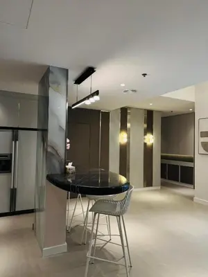 a dining room with a black table and chairs at Marina View Tower A in Dubai