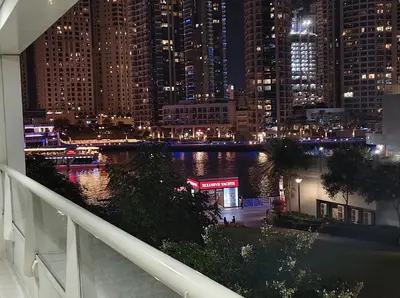 a view of a city at night from a balcony at Marina View Tower A in Dubai
