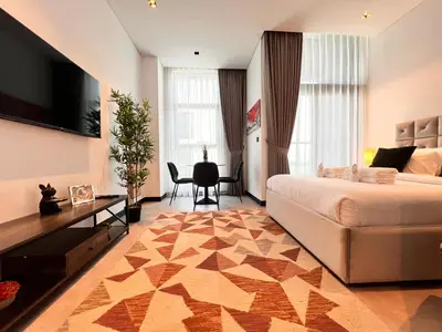 a hotel room with a bed and a table and chairs at Gennaro's Home at 15 Northside Business Bay in Dubai