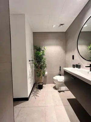 a bathroom with a toilet and a potted plant at Gennaro's Home at 15 Northside Business Bay in Dubai