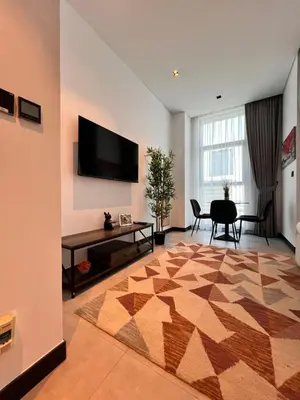 a living room with a flat screen tv on a wall at Gennaro's Home at 15 Northside Business Bay in Dubai