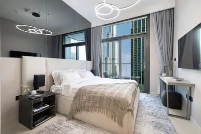a bedroom with a large bed and a large window at Luxury 4BR Burj Khalifa View Dubai Mall in Dubai