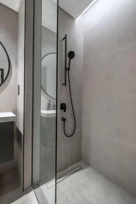 a shower with a glass door in a bathroom at Studio Revved Up in 15 Northside with Pool and Gym in Dubai
