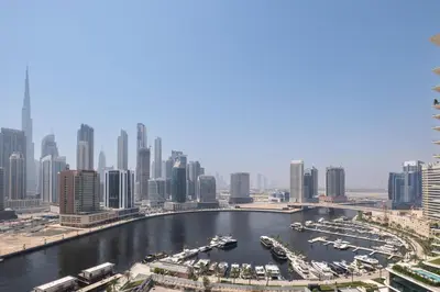 a view of a river with boats in a city at Studio Revved Up in 15 Northside with Pool and Gym in Dubai