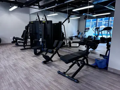 a gym with a bunch of exercise bikes in it at Oakley Square Oasis in JVC in Dubai
