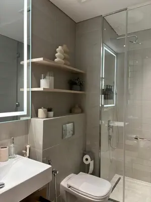 a bathroom with a shower and a toilet and a sink at Oakley Square Oasis in JVC in Dubai