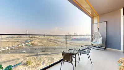 a room with a large window with chairs and a table at Locations I Binghatti Luna - JVC I Modern 1BR Apartment I Upgraded Interiors & Comfortable Stay I Scenic Community & Skyline Views in Dubai