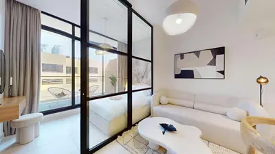 a living room with a couch and a table at Loci Residences - Vibrant Studio in JVC in Dubai