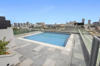 a swimming pool on the roof of a building at Loci Residences - Vibrant Studio in JVC in Dubai
