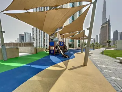 a playground with umbrellas on the roof of a building at Vacationer l High Rise 1 Bedroom l Close to Dubai Mall l Pool Access with Burj Khalifa Views in Dubai