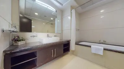 a bathroom with a sink and a bath tub at Vacationer I Lux 3 Bedroom Apartment I Steps from Barasti Beach in Dubai