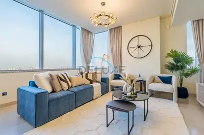 a living room with a blue couch and a table at Delightful 2BR at Sky Gardens DIFC by Deluxe Holiday Homes in Dubai