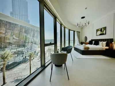 a bedroom with a bed and a large window at Venduras Homes -Grande Tower, Downtown Dubai, Burj Khalifa & Fountain Views in Dubai
