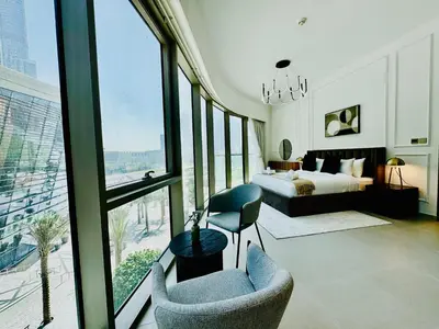 a bedroom with a bed and a large window at Venduras Homes -Grande Tower, Downtown Dubai, Burj Khalifa & Fountain Views in Dubai