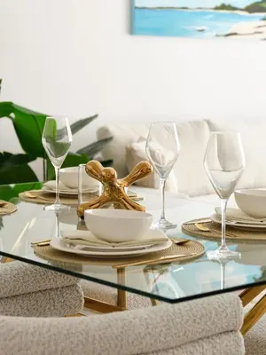 a table with glasses and a plate with a starfish on it at La Vie JBR Beatiful 1 Bed Seafront in Dubai