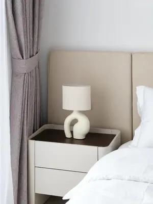 a bed with a nightstand with a lamp on it at La Vie JBR Beatiful 1 Bed Seafront in Dubai