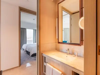 a bathroom with a sink and a mirror and a bed at Beach Rental- Grand Creek Harbour in Dubai in Dubai