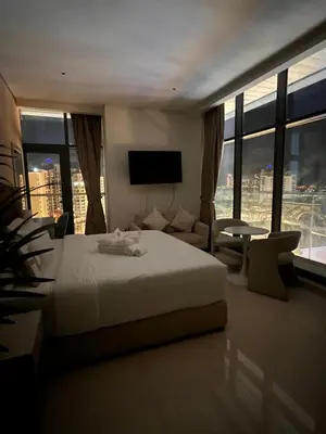 a hotel room with a bed and a large window at Suite in Seven Palm Corner Unit Rooftop Floor in Dubai