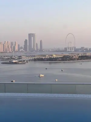 a view of a river with boats in a city at Suite in Seven Palm Corner Unit Rooftop Floor in Dubai
