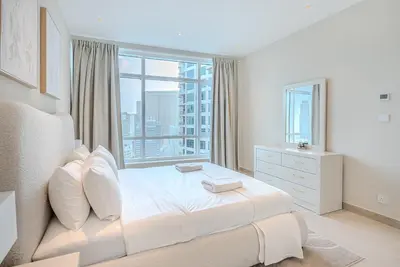 a bedroom with a white bed with a large window at Breathtaking 1BDR Apartment in Dubai Marina I Bonair I Park Islands in Dubai