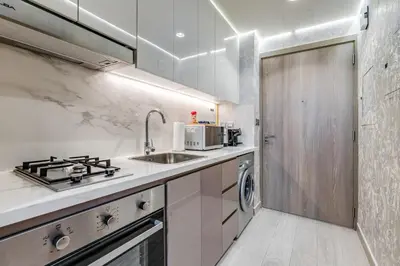 a kitchen with a sink and a stove at GLOBALSTAY Azizi Riviera 48 in Dubai