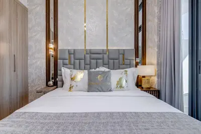 a bedroom with a large bed with white sheets and pillows at GLOBALSTAY Azizi Riviera 48 in Dubai