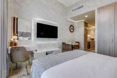 a hotel room with a large bed and a television at GLOBALSTAY Azizi Riviera 48 in Dubai